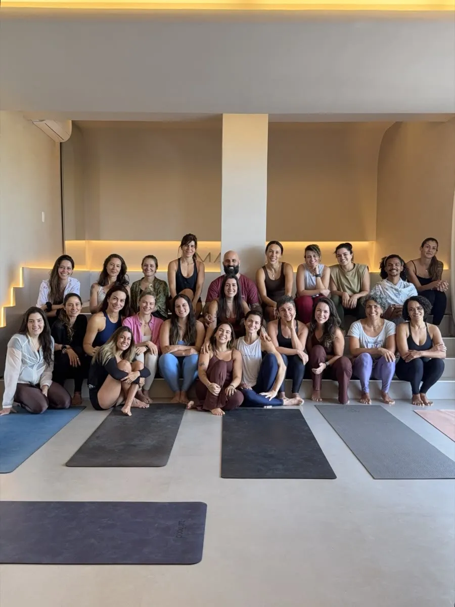 A turma reunida para a foto na sala do Manik Yoga, sob o logo da casa